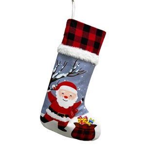 Detail of red and black plaid Christmas stocking with Santa Claus and plush white trim