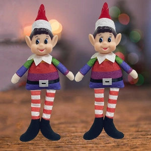 Detail of two Christmas elf ornaments with rainbow striped outfits on a wooden display