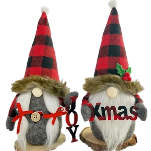Close-up of JOY and Xmas Christmas gnomes with red-black plaid hats and wood bases