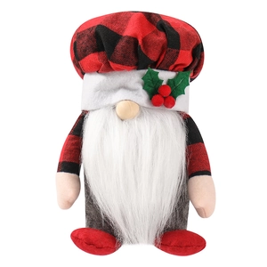 Dettaglio di uno gnomo di Natale con cappello a quadri rossi e foglie di agrifoglio