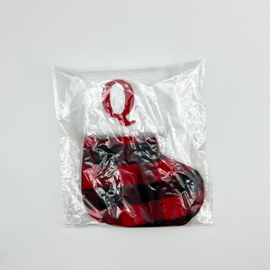 Detail of red and black buffalo plaid Christmas stocking with embroidered letter Q and fur cuff