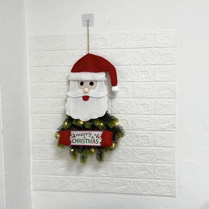 Detail of Christmas wreath with LED lights featuring Santa Claus and Merry Christmas sign