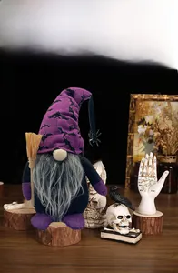 Macro view of a resin Halloween gnome with purple bat hat and mini broom detail