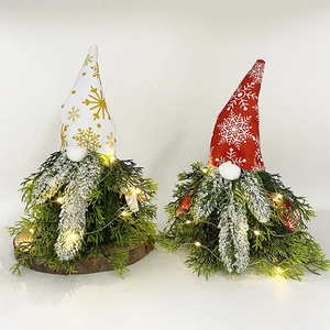 LED Christmas Gnomes with green pine needles and red snowflake hats on white background