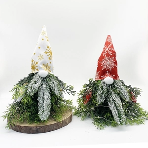 Close-up of Christmas gnomes with snowflake hats and textured evergreen branch beards