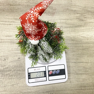 Detail view of gnome Christmas tree decoration with knit hat weighing 201g on scale