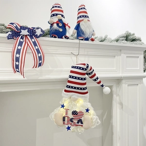 Lighted Independence Day gnome wall hanging with I Love USA sign on a white fireplace