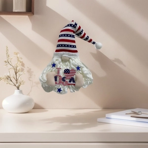 Detail of a Fourth of July gnome decor with USA heart sign on a minimalist home desk