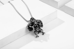 Detail of vintage Garuda pendant in titanium steel with intricate carvings and aged silver finish
