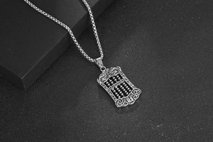 Macro shot of silver titanium steel abacus pendant with chinese character decoration