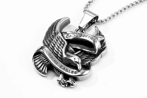 Macro detail of stainless steel eagle pendant with Philippine Eagles and Latin engraving