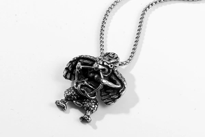 Detailed view of vintage titanium steel Roc pendant with intricate mythological bird carvings