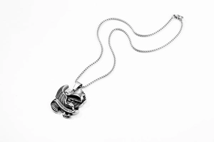 Detailed close-up of a vintage stainless steel eagle pendant with Philippines Eagle engraving