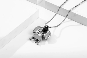 Detailed view of a silver eagle pendant on a square link chain with geometric background