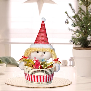 Christmas plush doll candy basket with blonde girl design and gold gift boxes on desk