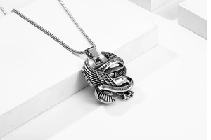 Detailed close-up of eagle pendant with Deo et Patriae engraving and pearl chain