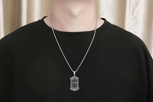 Detailed close-up of a silver abacus pendant necklace featuring a lucky Chinese character