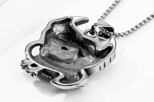 Detailed back view of vintage eagle mask pendant in aged silver stainless steel