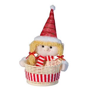 Close-up of a Christmas candy basket with a red-hatted doll and ivory woven base