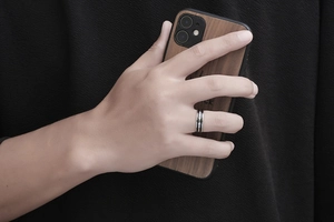 Detail of men's stainless steel ring with black inlay and three small cubic zirconia stones