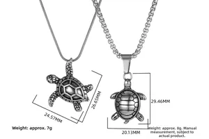 Detailed view of vintage turtle pendants with intricate shell textures and measurement specs
