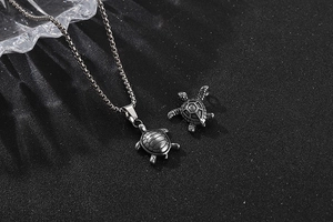 Macro shot of silver stainless steel sea turtle pendants with detailed shell texture