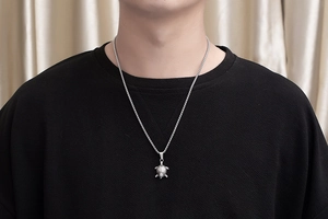 Detailed view of silver stainless steel sea turtle pendant on a box chain for women