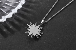 Macro view of vintage titanium steel sunburst star necklace with intricate carvings