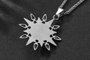Macro shot of a titanium steel star pendant with a thick wheat chain on dark texture