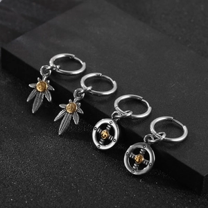 Set of four punk style eagle earrings with gold accents on matte black stone base