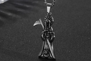 Close-up of gothic grim reaper pendant with scythe and scales in vintage silver finish