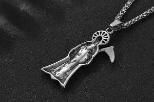 Close-up of vintage grim reaper pendant with scythe on braided steel chain