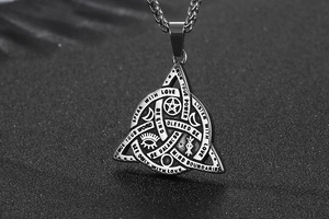 Detailed macro shot of vintage titanium steel triquetra pendant with mystical engravings