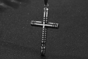 Detailed view of vintage titanium steel cross pendant with cylindrical dot textures