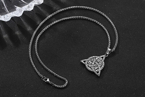 Detail of Celtic Triquetra pendant with mystical moon and star symbols in vintage steel