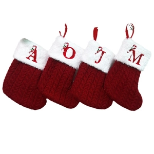 Set of 4 red knitted Christmas stockings with white faux fur trim and embroidered letters