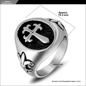 Detailed macro view of gothic cross engraving and fleur-de-lis motif on steel ring