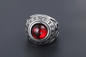 Macro shot of vintage titanium steel ring with a large red agate stone and carvings