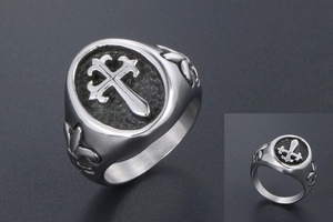 Close-up of vintage titanium steel cross ring with gothic fleur-de-lis engravings