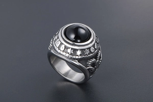 Macro view of vintage titanium steel ring with black onyx and embossed goat head