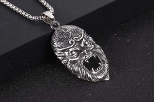 Macro shot of stainless steel Sun Wukong pendant with detailed Monkey King facial engraving