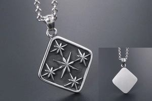 Macro view of square starburst relief pendant with polished finish and link chain