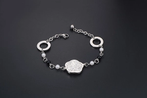 Détail macro du bracelet fleur argenté avec petits cristaux et accents de perles
