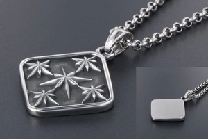 Macro detail of vintage titanium steel square pendant with embossed star engraving