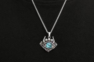 Gros plan d'un pendentif œil bleu avec crânes et chaîne de blé de style gothique
