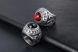 Macro view of vintage titanium steel rings with red and black agate and dragon relief