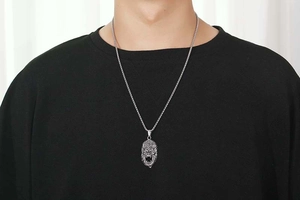 Close-up of a detailed stainless steel gorilla pendant on a rugged round link chain