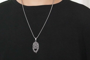 Detailed view of vintage Sun Wukong monkey mask pendant in silver-tone titanium steel