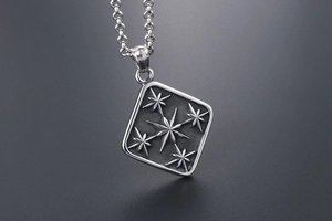 Macro shot of vintage titanium steel square pendant with embossed octagonal stars details