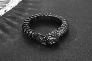 Detailed close-up of a retro silver dragon scale chain bracelet with carved dragon head